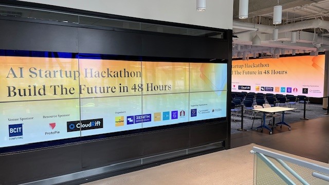 BCIT Tech Collider OLED screen with presentation area screen in the background